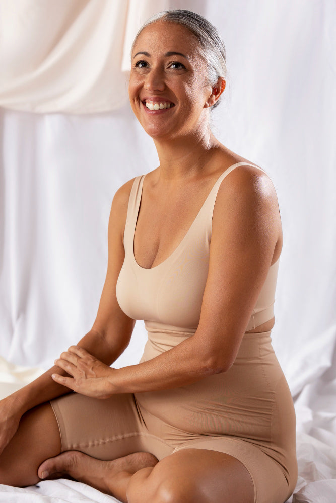 Side view smiley senior woman wearing shapewear
